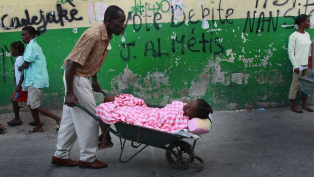 A patient with cholera symptoms taken to to the Doctors Without Borders (MSF) cholera treatment centre in the slum neighbourhood of Cite Soleil  in Port-au-Prince in 2010.
