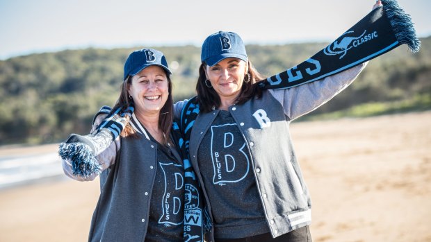 Jodie Hayne, (left) mother of Jarryd Hayne and Pam Richards, mother of Nathan Peats, pose in Blues gear on Umina Beach.