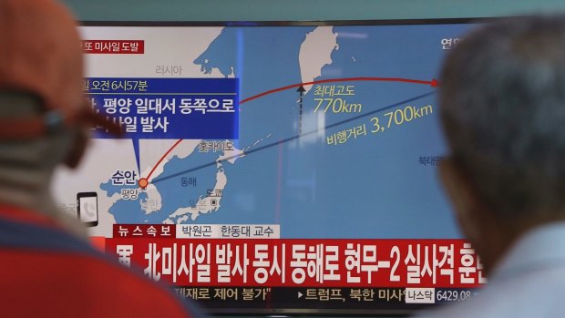 South Koreans watch a TV screen reporting a North Korea's missile launch,on Friday.