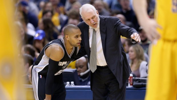 Instructions: San Antonio mentor Gregg Popovich gives directions to Patty Mills  during the game in which he earned his 1000th career win for his NBA career against the Indiana Pacers at Bankers Life Fieldhouse.
