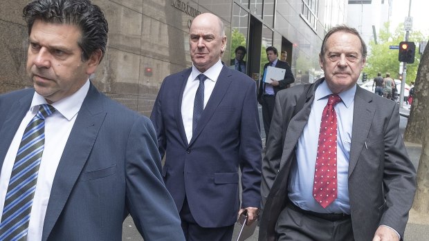 The ringleader of the Ultranet scandal, former education department deputy secretary Darrell Fraser (centre) leaves the IBAC inquiry.