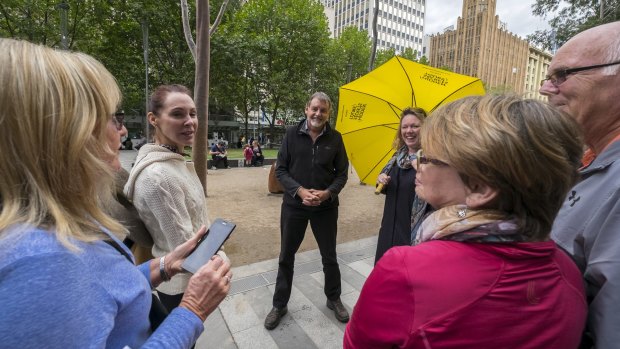 Melbourne Walking Festival organiser Stephen Ingrouille (centre) with walkers in Melbourne CBD.