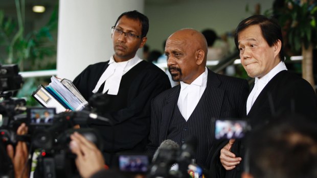 Hisyam Teh Poh Teik, right, and Naran Singh, centre, lawyers for Doan Thi Huong, speak to journalists after the court hearing.