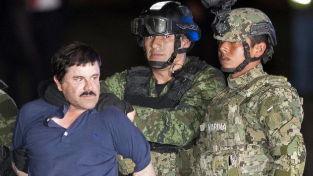 El Chapo is made to face the press as he is escorted to a helicopter following his recapture in January.