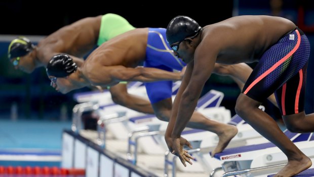 Robel Habte, right, of Ethiopia, competes in the Men's 100m freestyle heats.