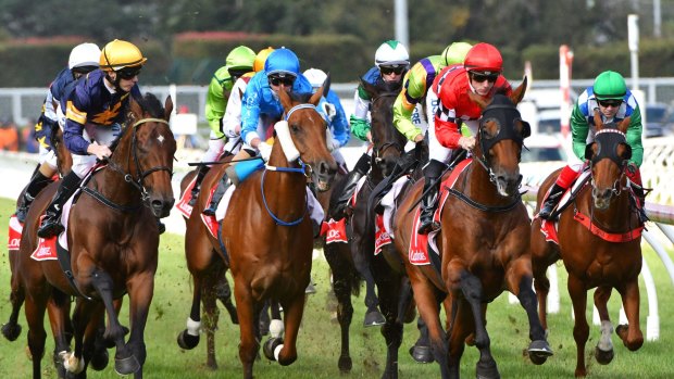 Beau Mertens riding Boom Time (right) in the first lap before winning at Caulfield Racecourse.