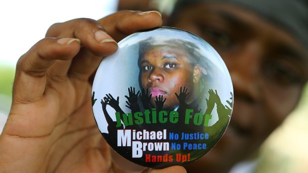 Nikki Jones, of Spanish Lake, Missouri, holds a button in support of Michael Brown.