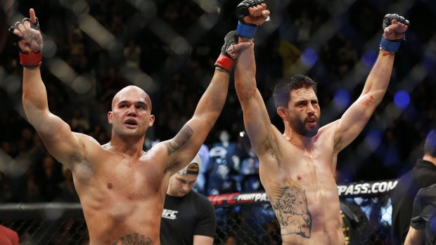 Robbie Lawler, left, and Carlos Condit celebrate after their welterweight championship bout at UFC 195 in Las Vegas.