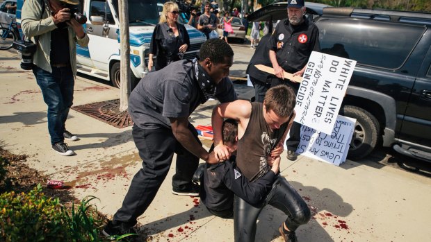 Counter-protesters scuffled with a KKK members during an anti-immigration rally in Anaheim