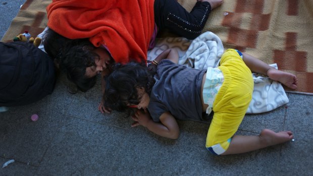 Refugee children sleep on the outdoor floor of the Keleti railway station in Budapest, Hungary.
