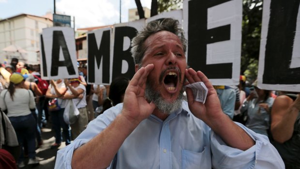 A man shouts slogans against Venezuela's President Nicolas Maduro's government during a protest also commemorating the country's Day of the Journalist, in Caracas, on Tuesday.