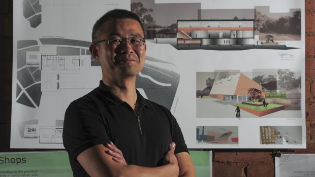 University of Canberra architecture student Cornelius Pau, of Dunlop, stands before his design.