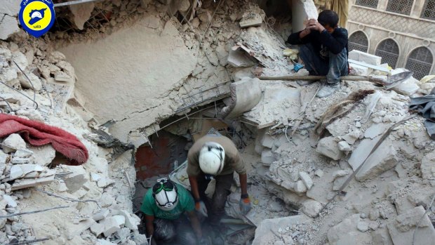 White Helmets dig in the rubles to remove bodies and look for survivors, after airstrikes hit the Bustan al-Basha neighbourhood in Aleppo, Syria. 