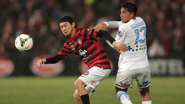 Battle for possession: Wanderers import Yojiro Takahagi is challenged by Melbourne City's Jonatan Germano at Pirtek Stadium.