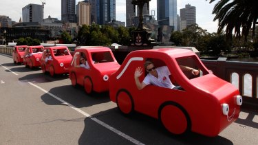 Coles' "little red cars" have become the symbol of its insurance business.