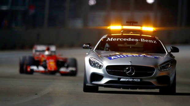 The safety car drives ahead of Sebastian Vettel.