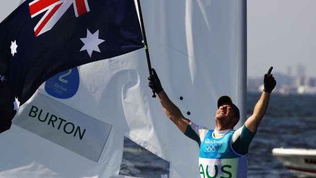 Tom Burton of Australia celebrates winning the gold medal in the Men's Laser class.