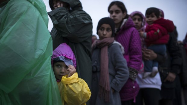 Refugees queue for food on the Greek-Macedonia bordering Idomeni, Greece, on Monday.