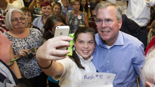 Mobile generation: Eden Blackman, 13, from Mobile, Alabama, left, takes a selfie with Republican presidential candidate, Jeb Bush.