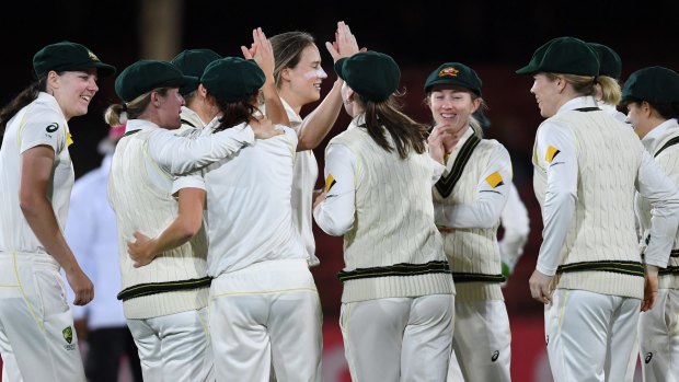 Breakthrough: Ellyse Perry celebrates the wicket of Georgia Elwiss, caught by Megan Schutt. 