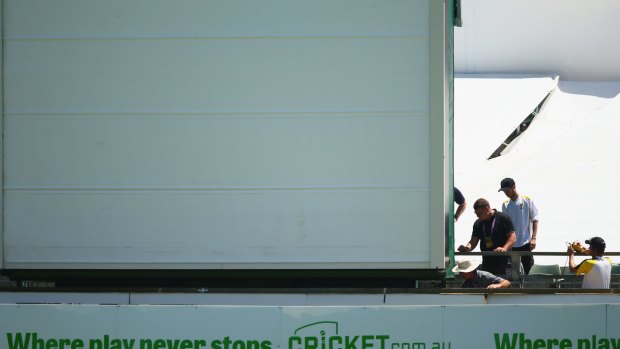 Sightscreen attendants look to repair it during day three.