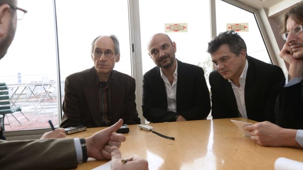 'We're really back': Editor-in-chief of French satirical weekly Charlie Hebdo Gerard Briard, lawyer of Charlie Hebdo Richard Malka and French columnist for Charlie Hebdo Patrick Pelloux speak to the press at the headquarters of French newspaper <i>Liberation</i>.