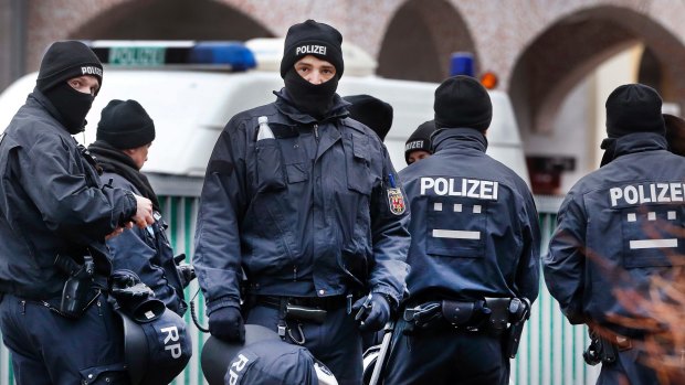 German police officers stand guard in front of a mosque during a terror raid in Frankfurt, Germany, on Wednesday.