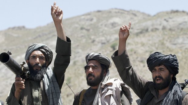 Taliban fighters listen to senior Taliban leader Mullah Abdul Manan Niazi in Herat. 