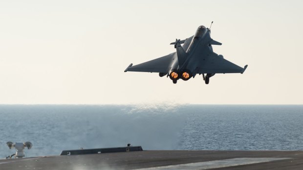 A Rafale fighter jet takes off from the deck of French aircraft carrier Charles De Gaulle.