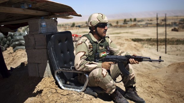 A Kurdish Peshmerga fighter holds a position.