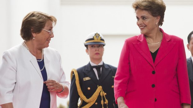 Brazilian President Dilma Rousseff, right, smiles at Chilean President Michelle Bachelet in Santiago, Chile, on Friday.