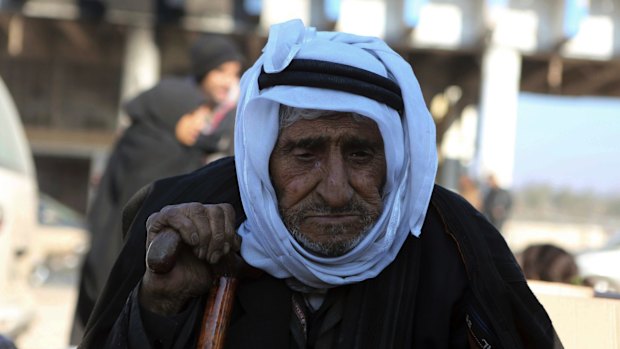 An old Syrian man evacuated from Aleppo arrives at a refugee camp in Rashidin, near Idlib, Syria.