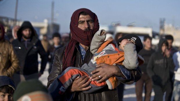 Syrians, many from Aleppo, walk towards the Turkish border at the Bab al-Salam border gate last week. 