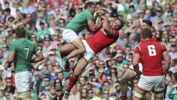 Ireland's Dave Kearney, centre left,  and Wales' Jamie Roberts, centre right, battle for the ball during a Rugby World Cup warm-up Match in  Dublin on Saturday. 