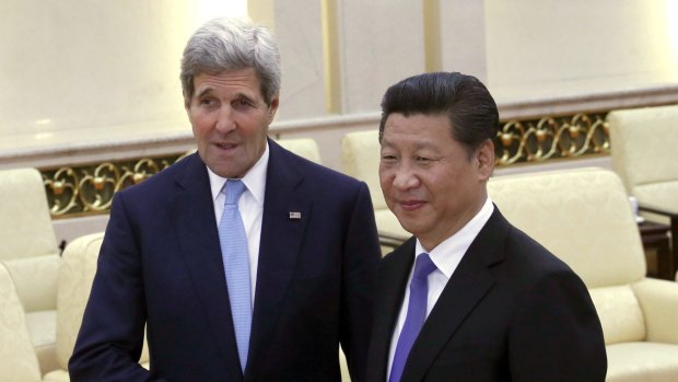 U.S. Secretary of State John Kerry, left, shakes hands with Chinese President Xi Jinping at the Great Hall of the People at the Great Hall of the People in Beijing, China, Sunday, May 17, 2015.  Kerry was meeting Sunday with Chinese President Xi before heading to South Korea to complete a short Asian tour that has been clouded so far by concerns over China's construction in South China Sea. (Kim Kyung-Hoon/Pool Photo via AP)