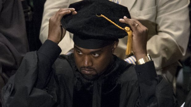 Kanye West adjusts his cap before receiving his honorary doctorate. 