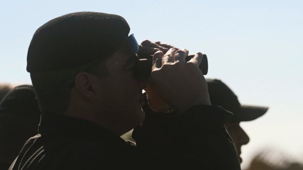An official looks through his binoculars at an Afriqiyah Airways plane on the tarmac at Malta's Luqa International airport on Friday.