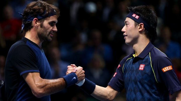Roger Federer shakes hands with Kei Nishikori after his victory in their match at Barclays ATP World Tour Finals in 2015 in London.