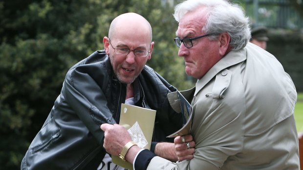 Canadian Ambassador to Ireland Kevin Vickers, right, wrestles with a protester during a State ceremony to remember the British soldiers who died during the Easter Rising.