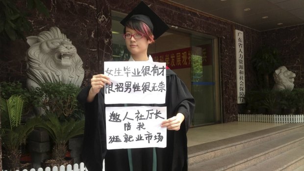 Female activist Zheng Churan, 25, with papers that read "Women graduates are talented, only hiring men is frustrating"  and "I invite the head of Human Resources and Social Security department to go to the job market with me".
