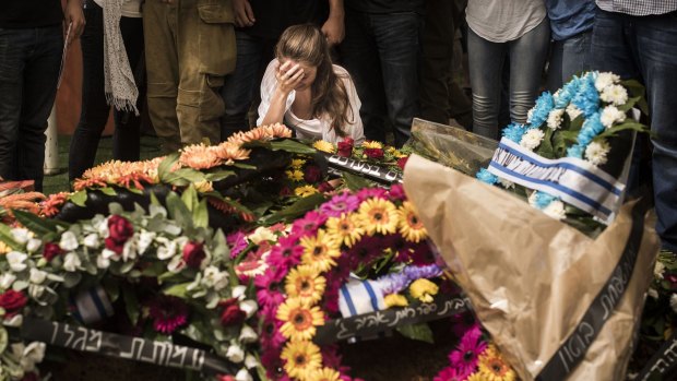 Family mourn an Israeli soldier in Tel Aviv during the hours before the ceasefire. Sixty-one Israeli soldiers and three civilians have been killed since the conflict began on July 8.