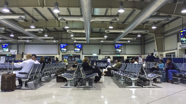Travellers wait at the boarding gate at Bahrain International Airport.