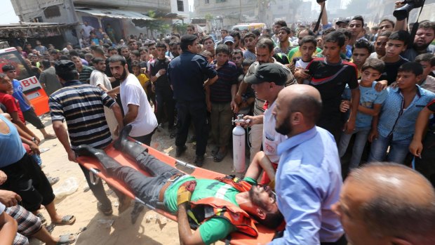 A Palestinian man wounded in the explosion is carried on a stretcher in Rafah in the Gaza Strip.