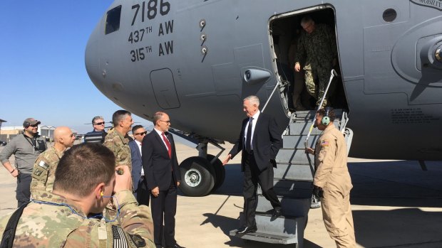 US Secretary of Defence Jim Mattis, second from right, is greeted by US Ambassador Douglas Silliman as he arrives at Baghdad International Airport, Iraq, on Monday.