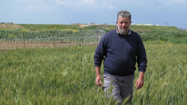 Pablo Leffler stands in the farmlands of Kibbutz Ein HaShlosha. The structures and razor wire behind him surround the Hamas tunnels discovered by the Israel Defence Forces last year.