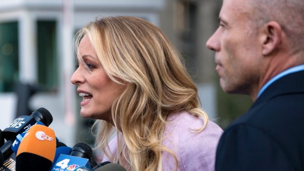 Porn actress Stormy Daniels speaks outside federal court in New York on Monday, as her attorney Michael Avenatti listens.  