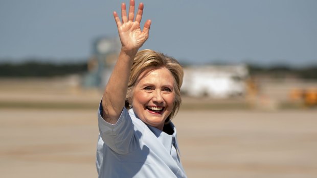 Hillary Clinton waves as she arrives at Cleveland Hopkins International Airport. Some conspiracy theorists have even claimed the candidate's facial expressions are a sign of illness.