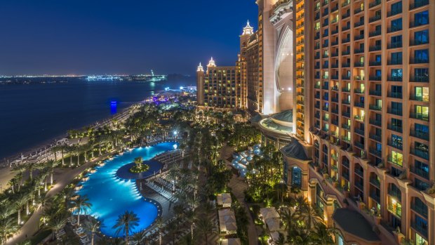 The building and royal pool at night.