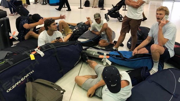 A group of surfers from Sydney wait for updates on their cancelled flight to Sumatra via Denpasar on November 27, 2017.