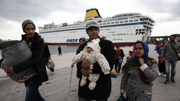Migrants and refugees arrive from the Lesbos and Chios at the Athens' port of Piraeus on Sunday.
